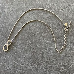 Silver necklace with bling-y attachment.